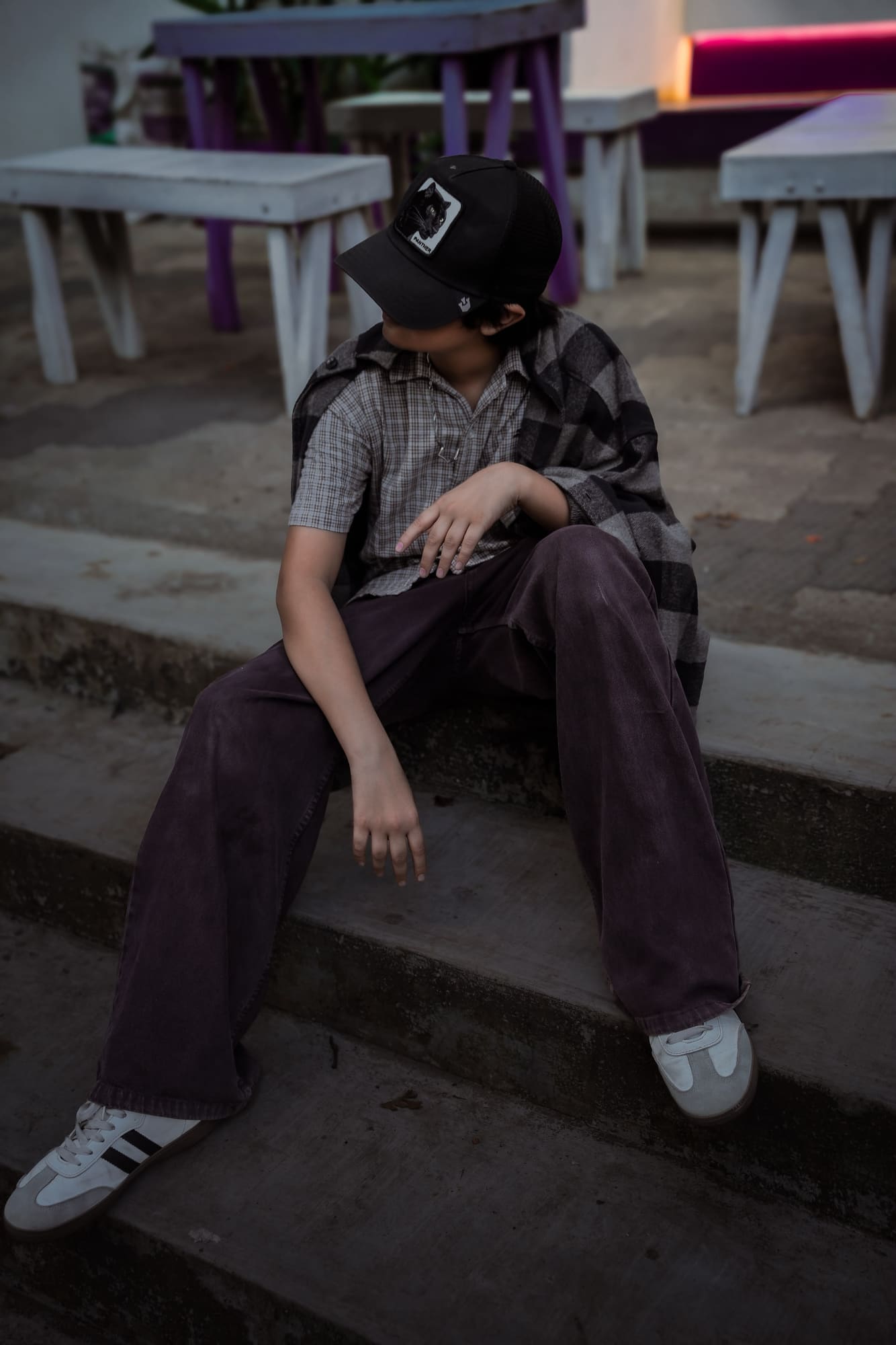 Portrait seated on concrete steps at dusk