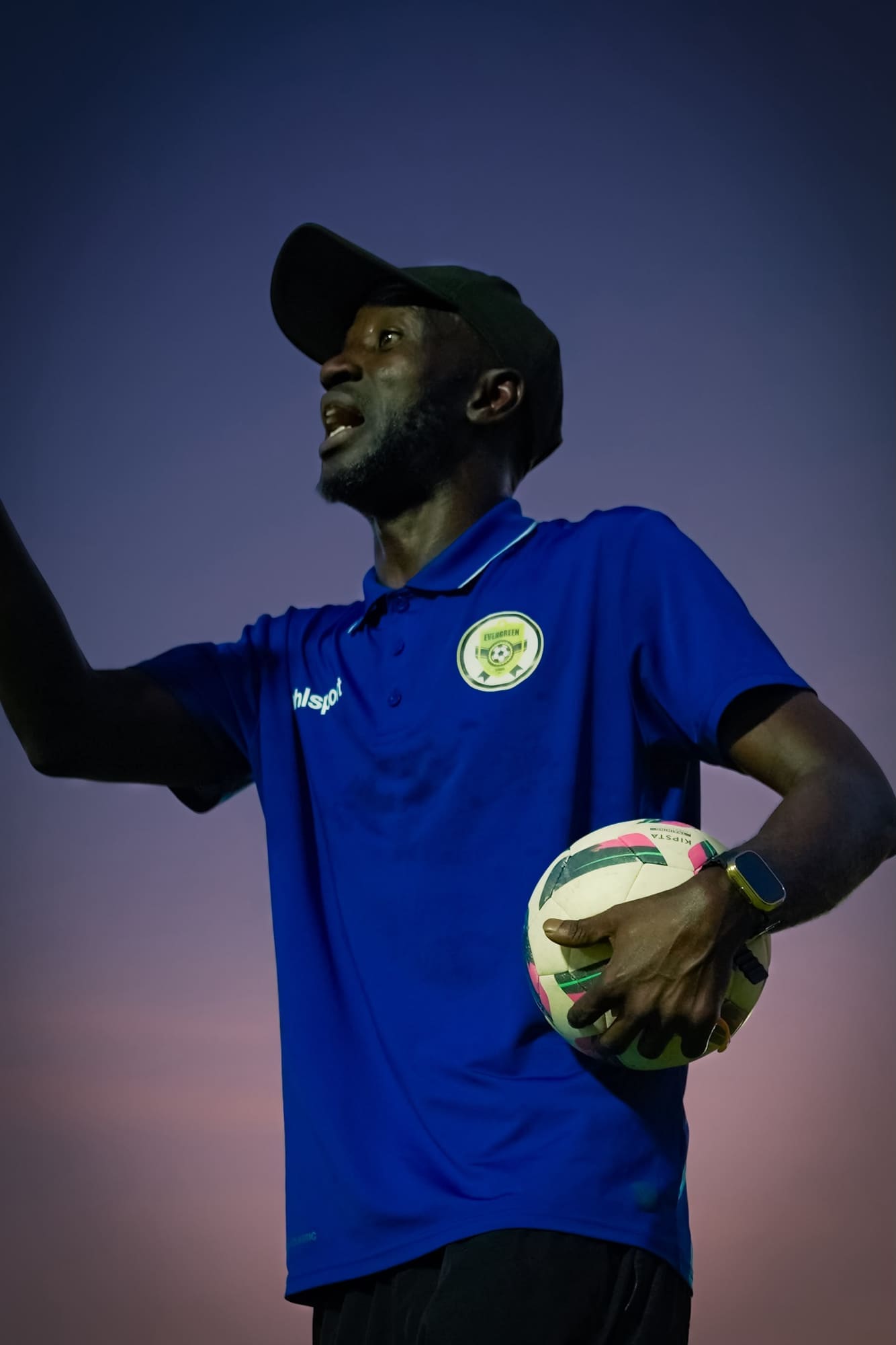 Portrait of a coach holding a match ball at dusk