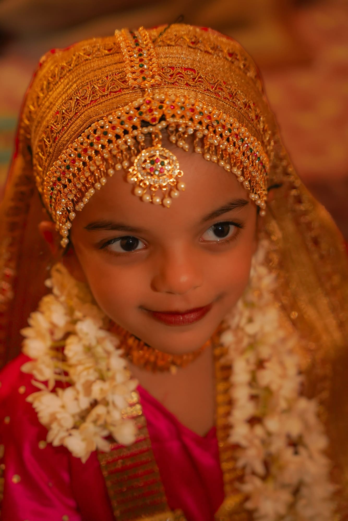 Young girl in a jewelled headdress with jasmine flowers