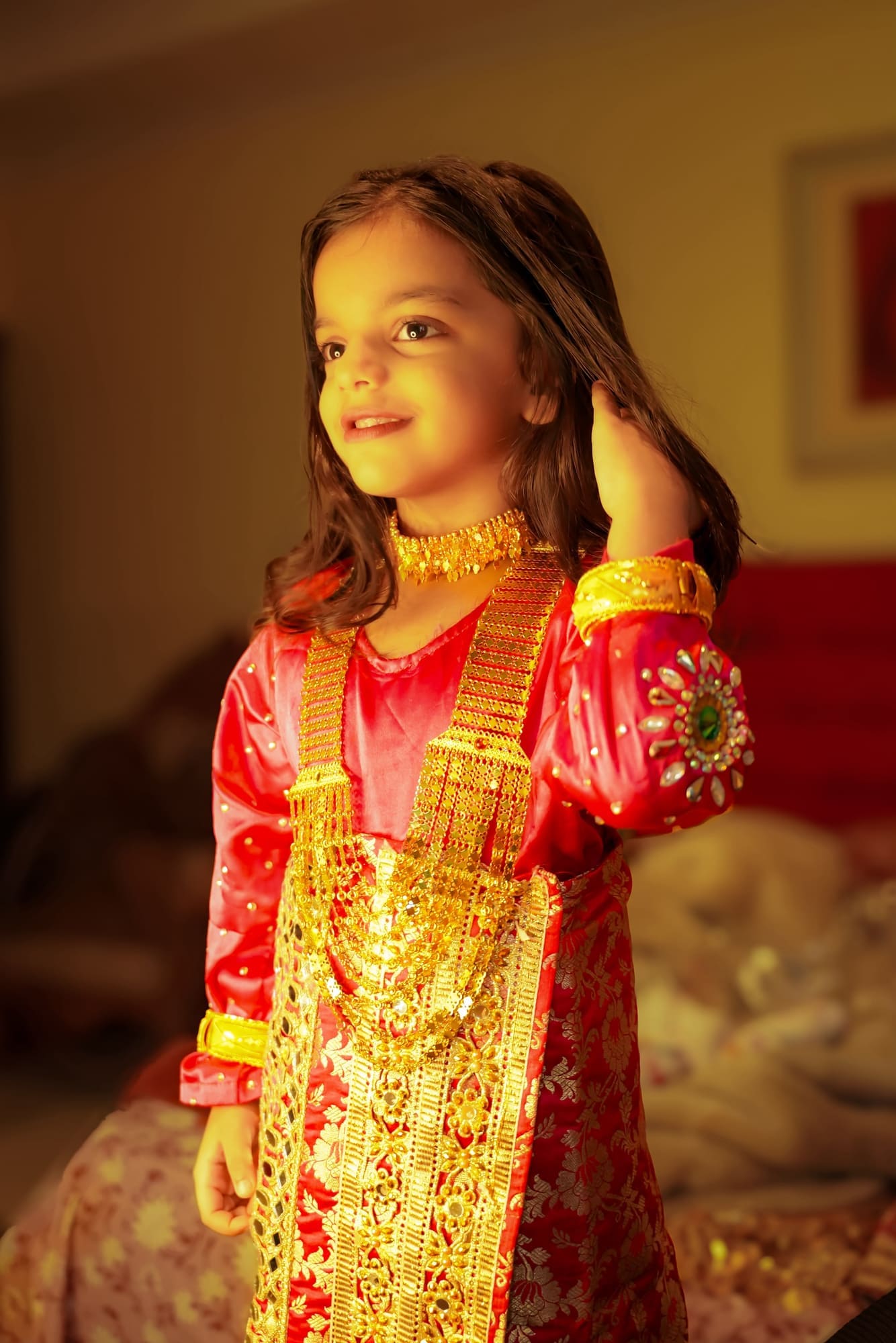 Young girl in red and gold festive dress