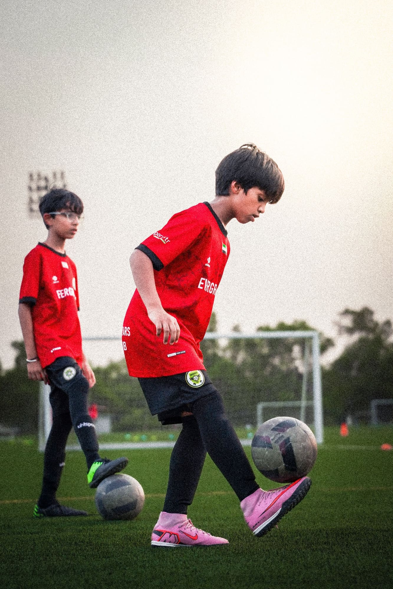 Two players warming up at dusk
